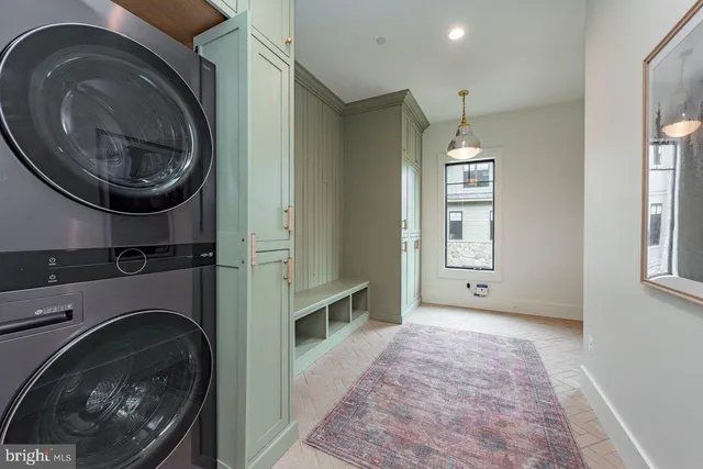 a bedroom with a bed and a flat tv screen on dresser