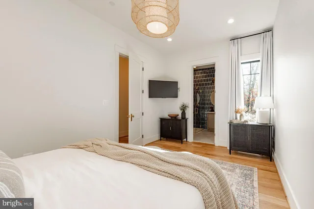 a bedroom with two beds and a large window