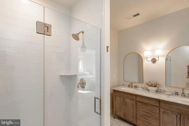 a bedroom with two beds and a flat screen tv