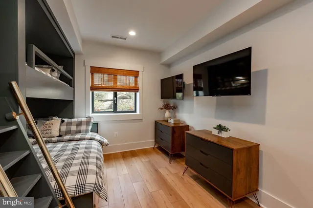 a bathroom with a sink a toilet a mirror and shower