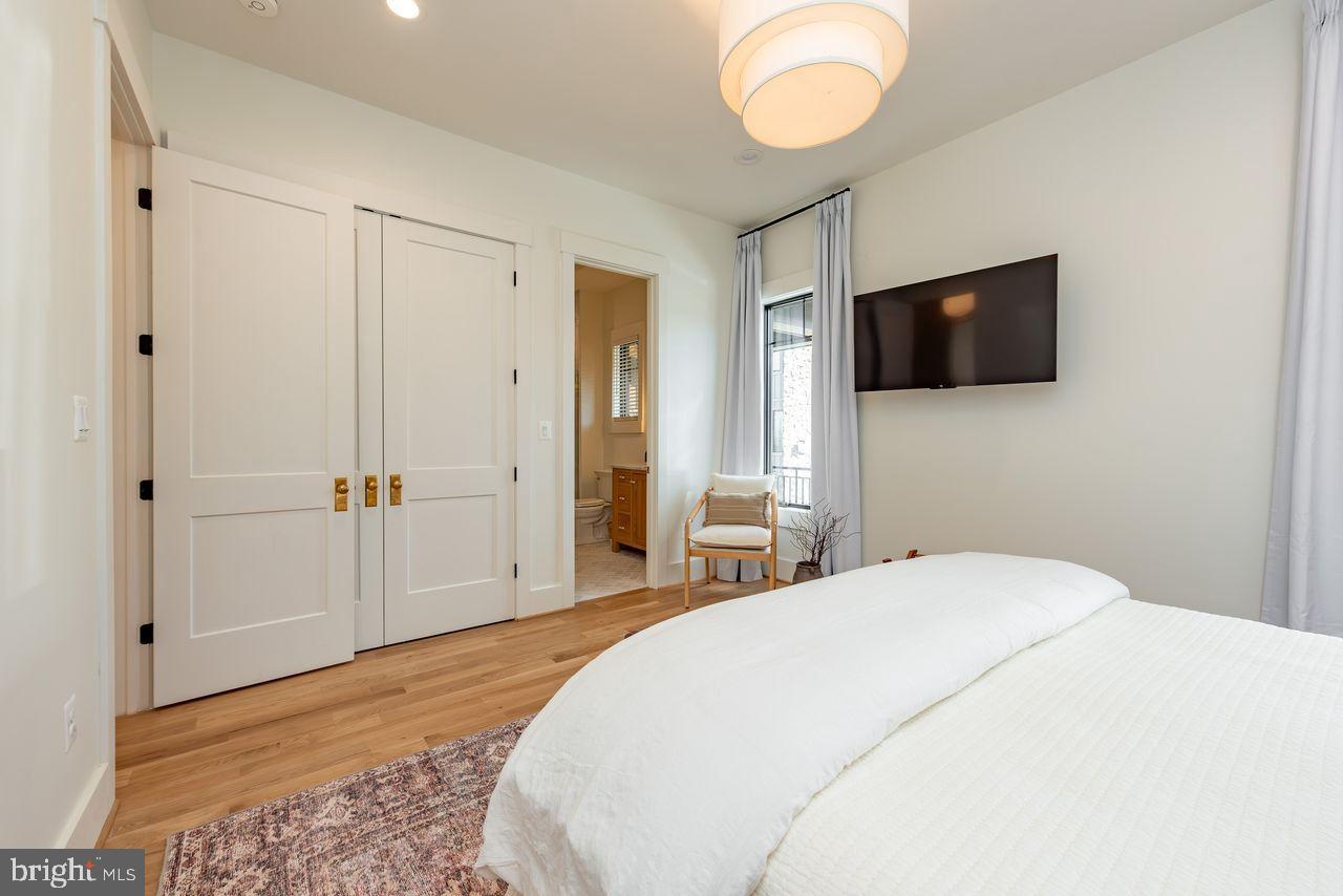 142 Ridge Run Road McHenry, MD 21541 - Photo 36 of 58 a bedroom with a bed and a flat screen tv