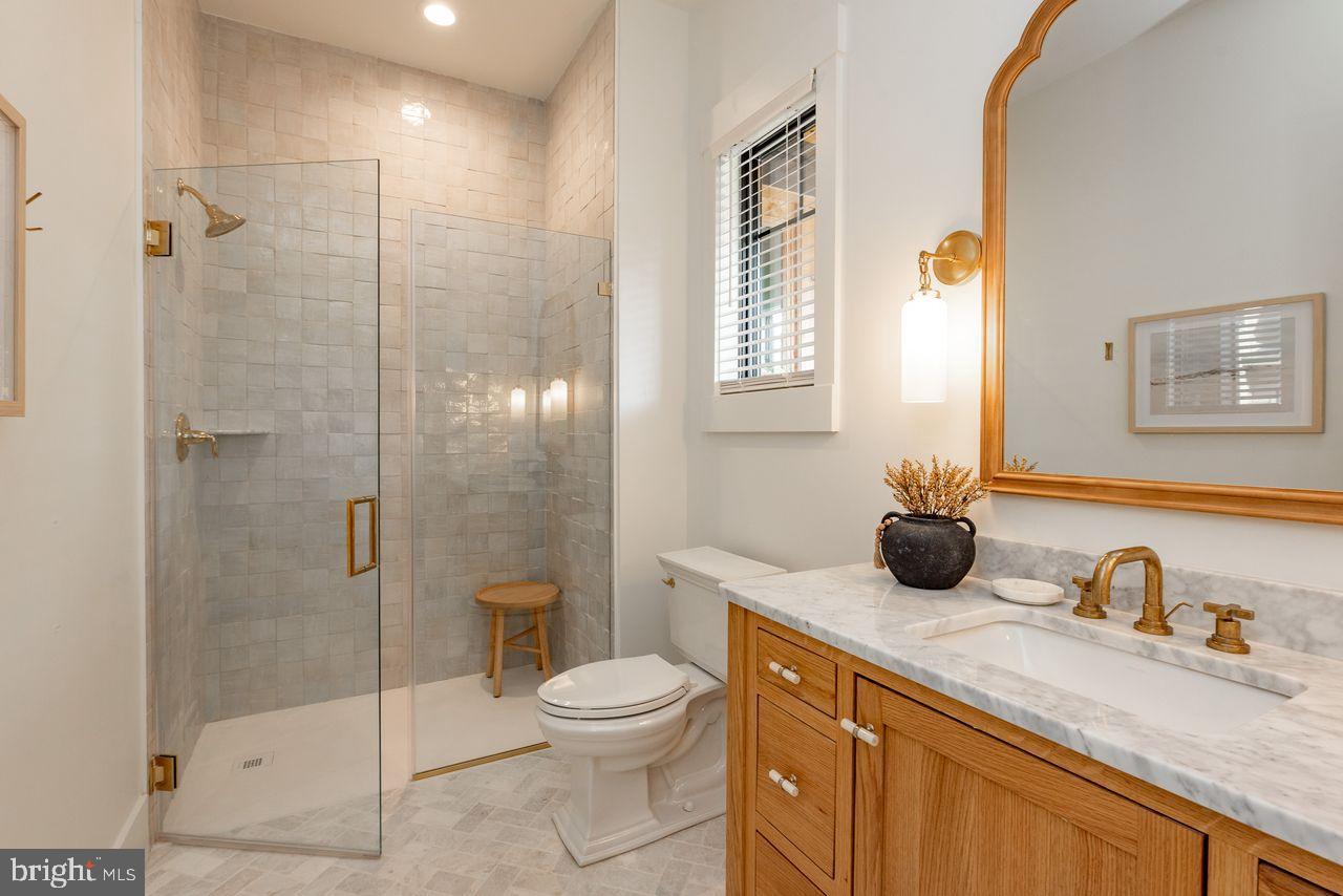 142 Ridge Run Road McHenry, MD 21541 - Photo 37 of 58 a bathroom with a granite countertop sink a mirror a toilet and shower