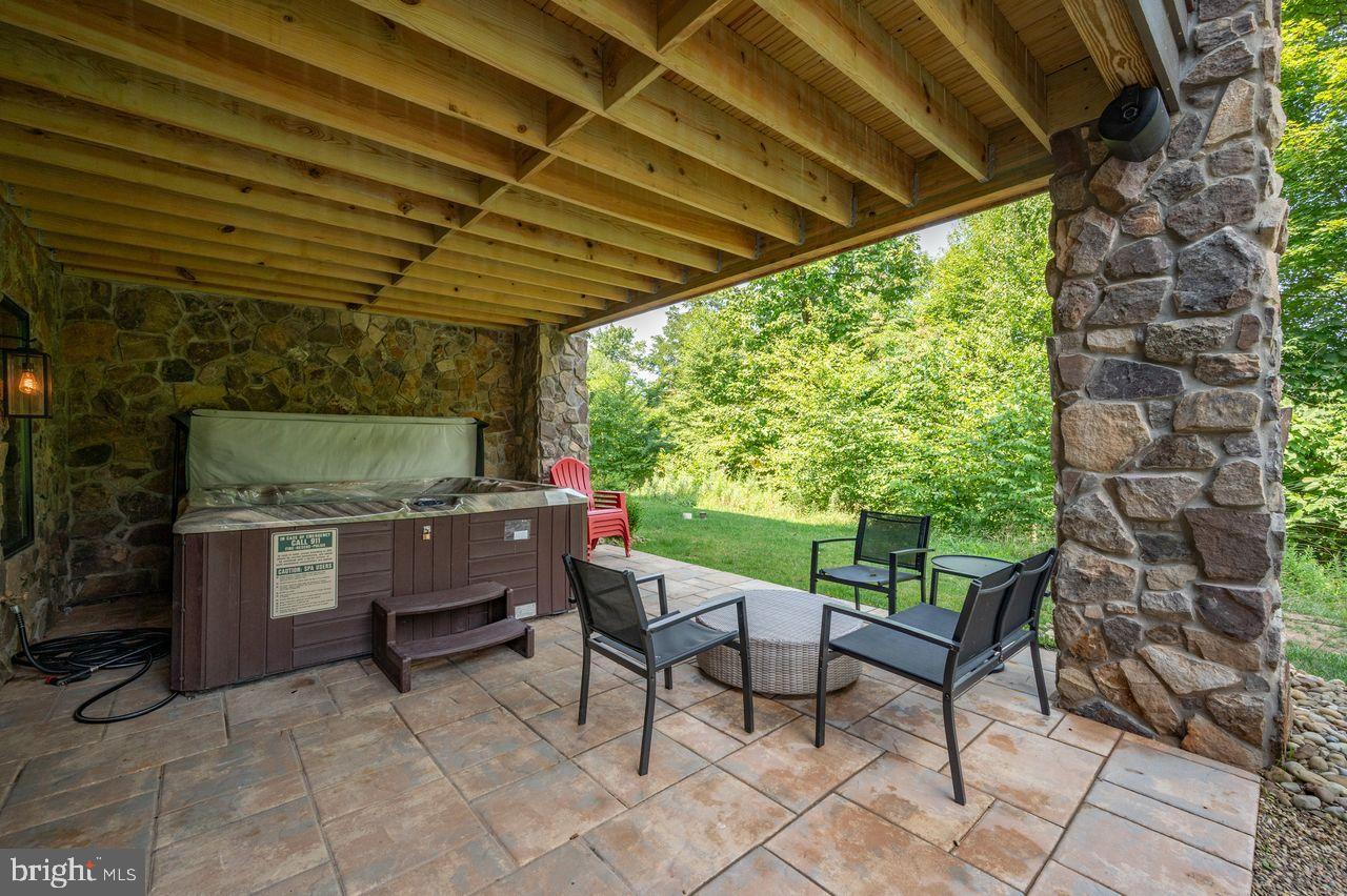 142 Ridge Run Road McHenry, MD 21541 - Photo 50 of 58 a view of a patio with table and chairs with wooden floor and fence