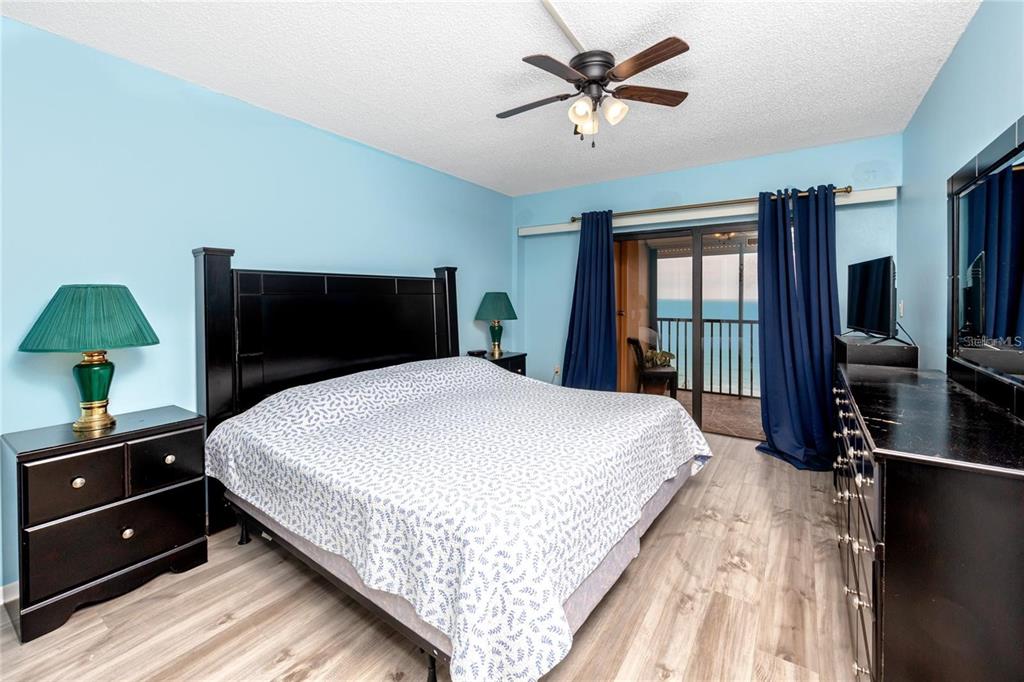 13720 Gulf Boulevard, Unit 503 Madeira Beach, FL 33708 - Photo 11 of 12 a bedroom with a large bed and a tv