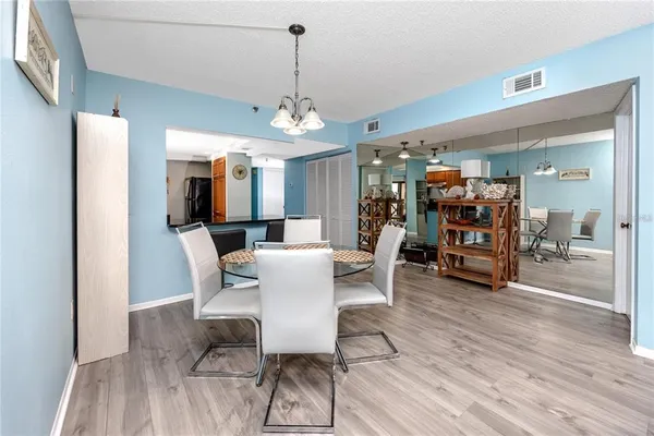 a view of a dining room with furniture and wooden floor