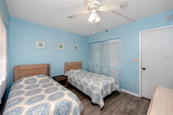 a bedroom with two beds and painted walls