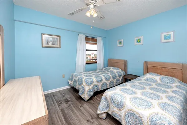a bedroom with two beds and a chandelier
