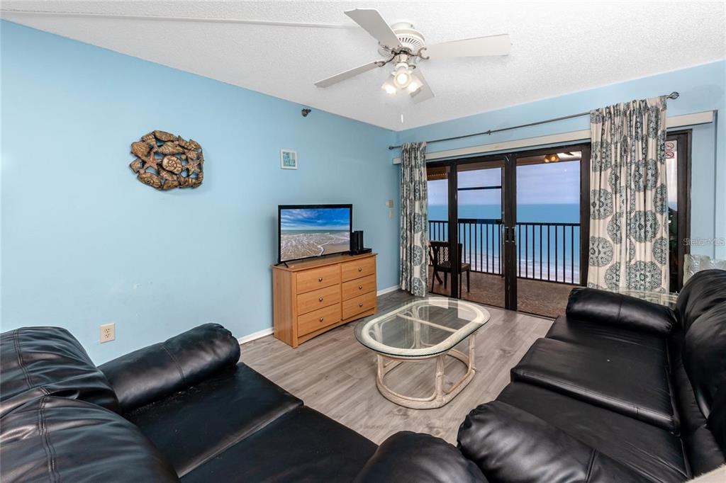 13720 Gulf Boulevard, Unit 503 Madeira Beach, FL 33708 - Photo 5 of 12 a living room with furniture and a window