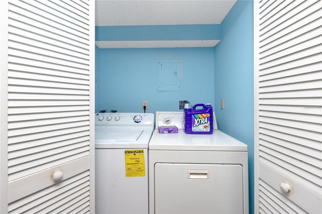 13720 Gulf Boulevard, Unit 503 Madeira Beach, FL 33708 - Photo 9 of 12 a utility room with dryer and washer