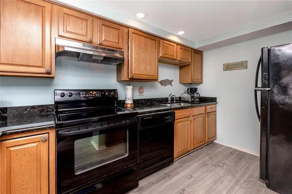 a kitchen with stainless steel appliances granite countertop a stove microwave and refrigerator
