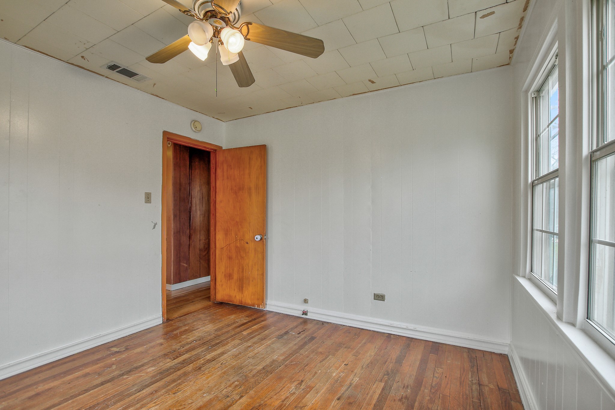 921 West 5th Street Taylor, TX 76574 - Photo 16 of 29 wooden floor in an empty room with a window