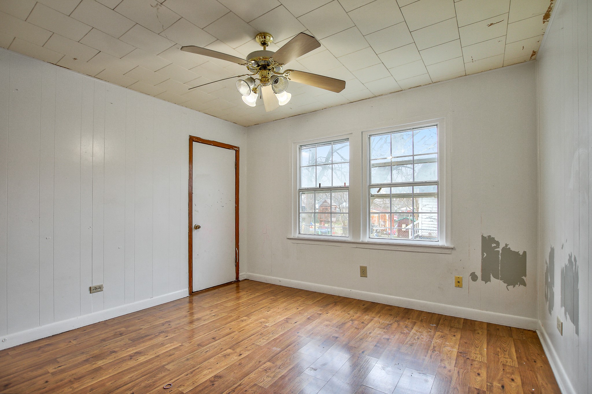 921 West 5th Street Taylor, TX 76574 - Photo 17 of 29 a view of an empty room with wooden floor and a window