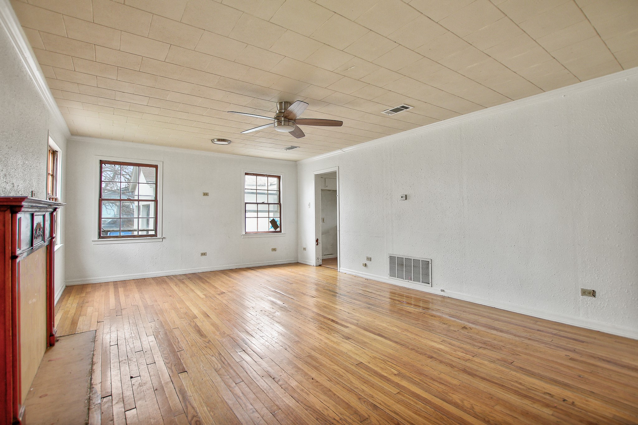 921 West 5th Street Taylor, TX 76574 - Photo 3 of 29 a view of an empty room with wooden floor and a window
