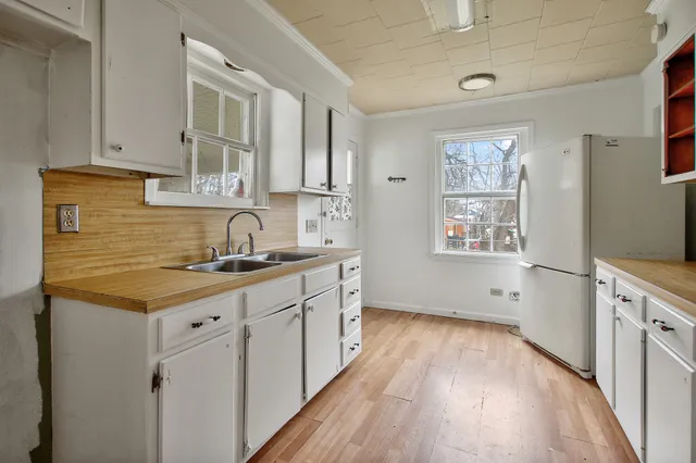 a kitchen with granite countertop a sink stove and cabinets