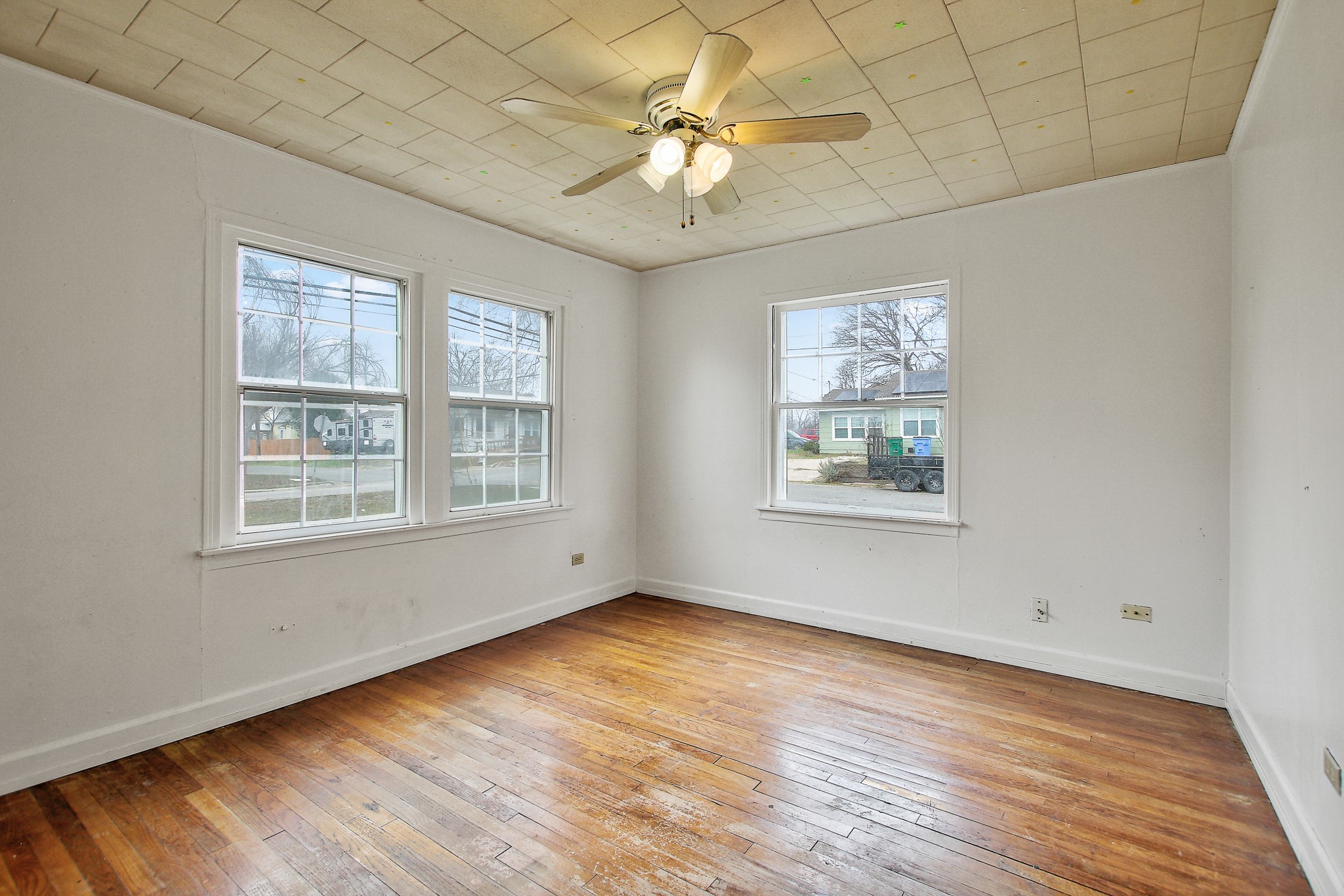 921 West 5th Street Taylor, TX 76574 - Photo 10 of 29 a view of an empty room with a window and wooden floor