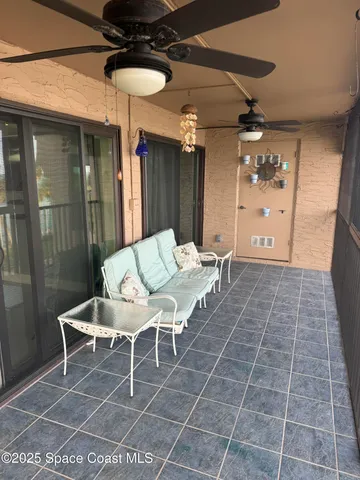 a balcony with table and chairs