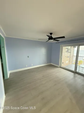 an empty room with windows and entrance