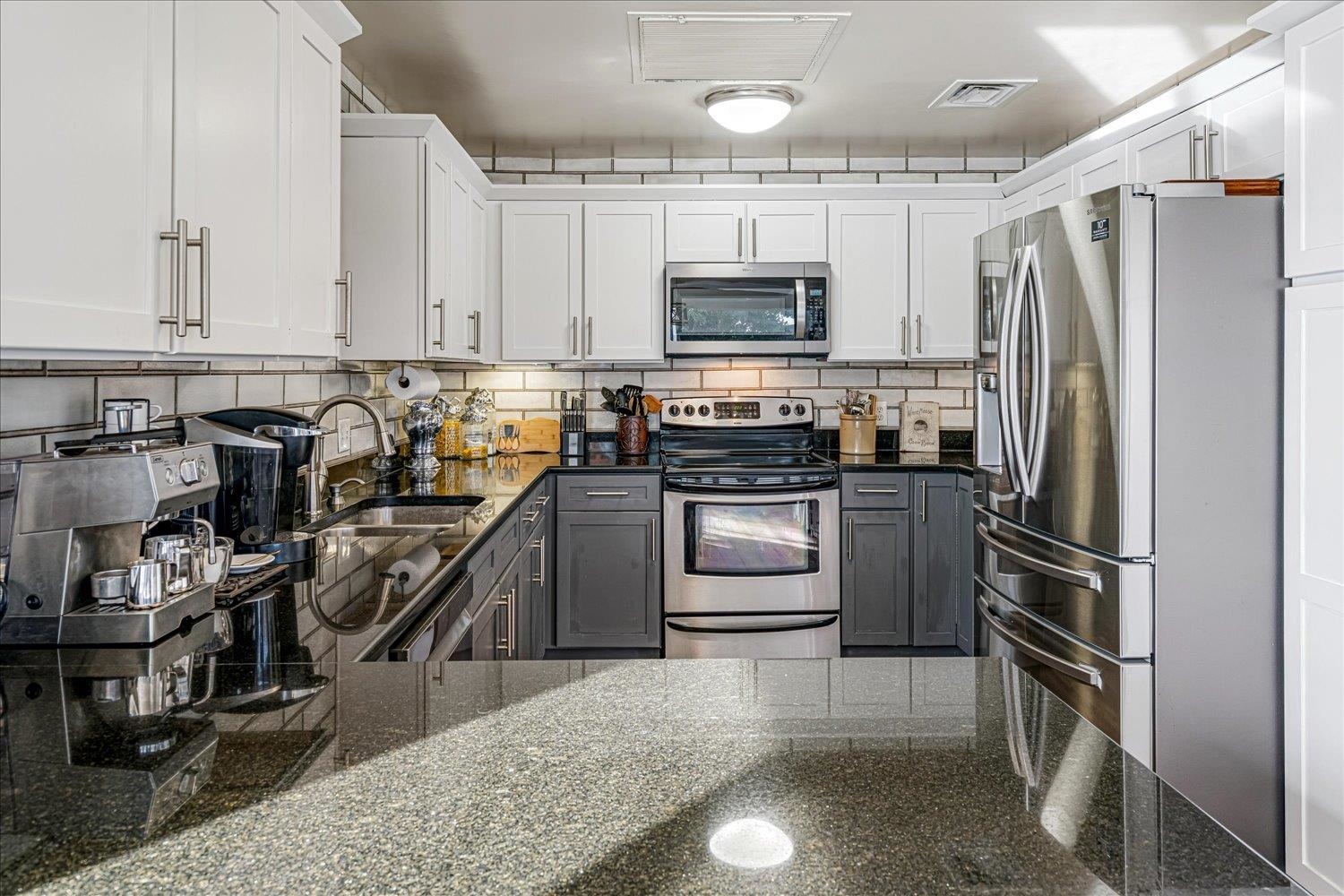 655 Riverside Drive, Unit 202 Memphis, TN 38103 - Photo 17 of 37 a kitchen with kitchen island a counter top space stainless steel appliances and cabinets