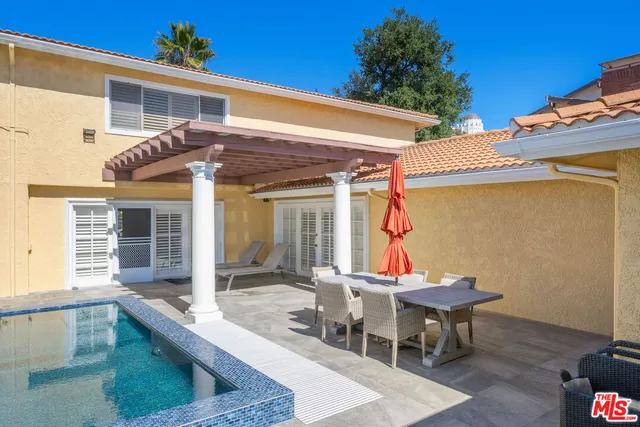 a view of a balcony with table and chairs