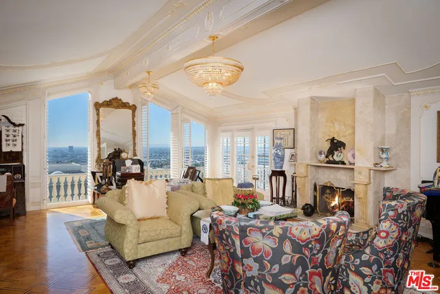a living room with fireplace furniture and a floor to ceiling window