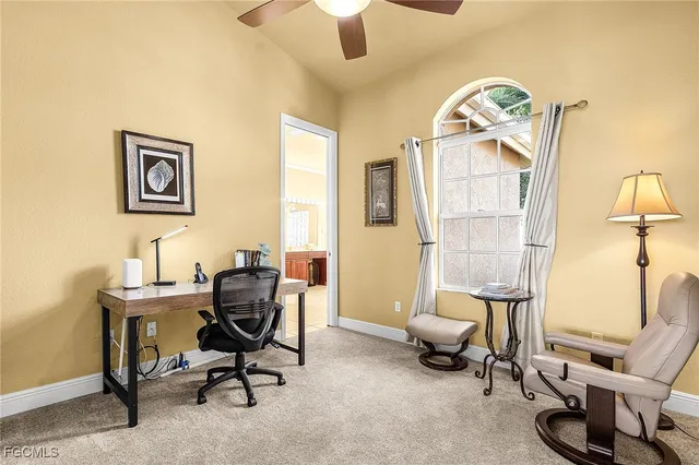 a view of a livingroom with workspace and a couch