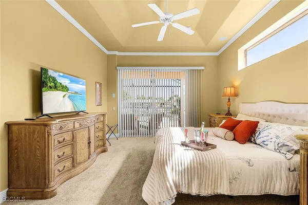 a bedroom with a large bed and a flat screen tv