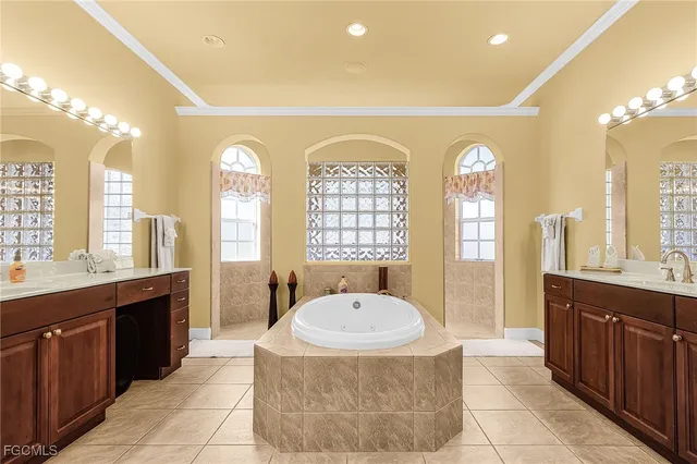 a spacious bathroom with a tub sink and mirror