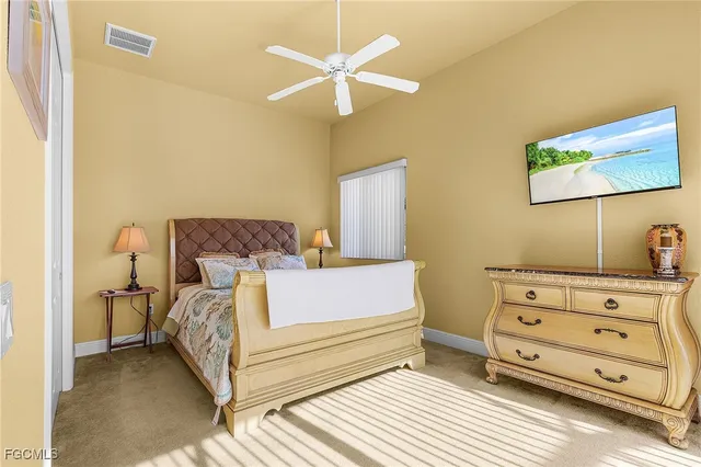 a bedroom with a bed and a ceiling fan