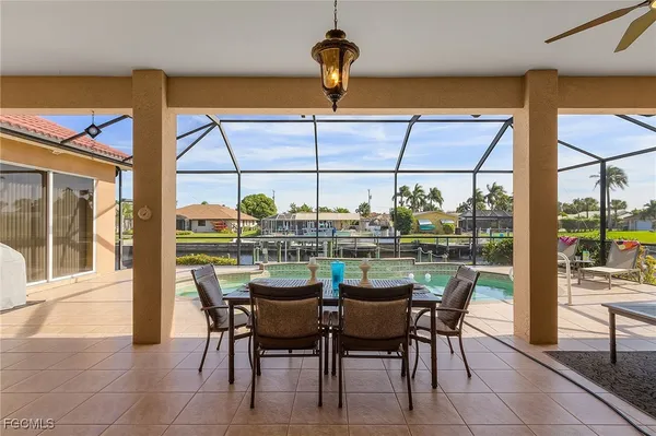 a dining room with furniture and a floor to ceiling window