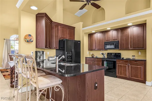 a kitchen with stainless steel appliances granite countertop wooden cabinets a stove top oven a sink and dishwasher