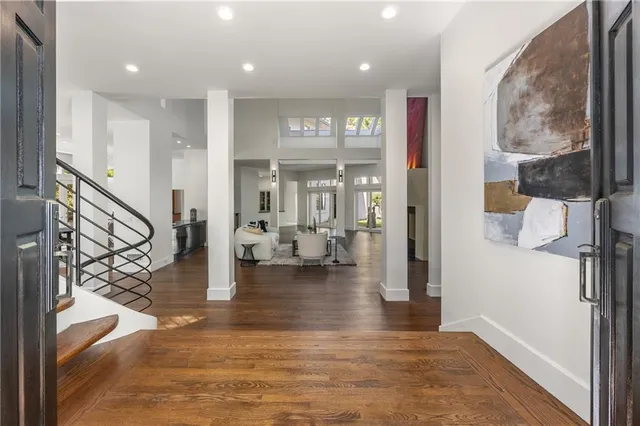 a view of an entryway with wooden floor and a living room