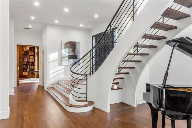 a view of entryway and hall with wooden floor