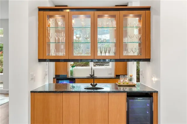 a kitchen with granite countertop wooden cabinets and a window