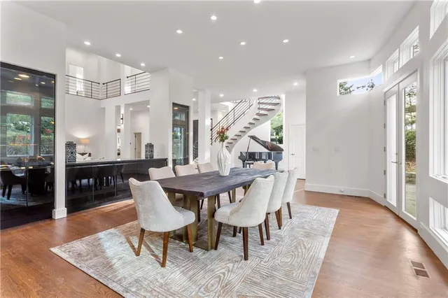 a view of a a dining room with furniture window and wooden floor