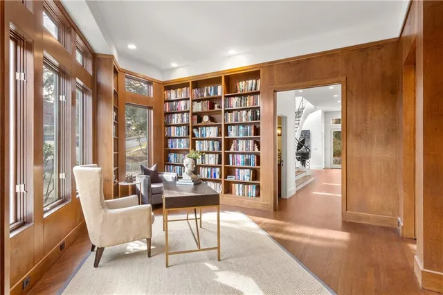 a living room with furniture and a floor to ceiling window
