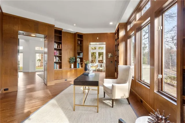 a living room with furniture and large windows