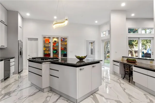 a kitchen with stainless steel appliances granite countertop a sink and cabinets