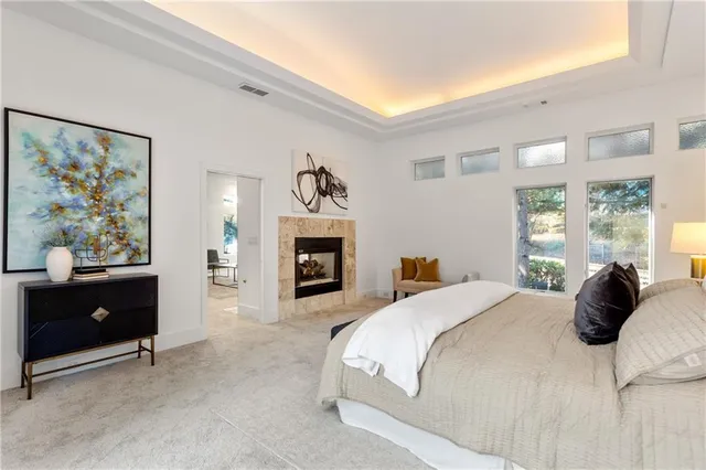 a bedroom with a bed and a fireplace