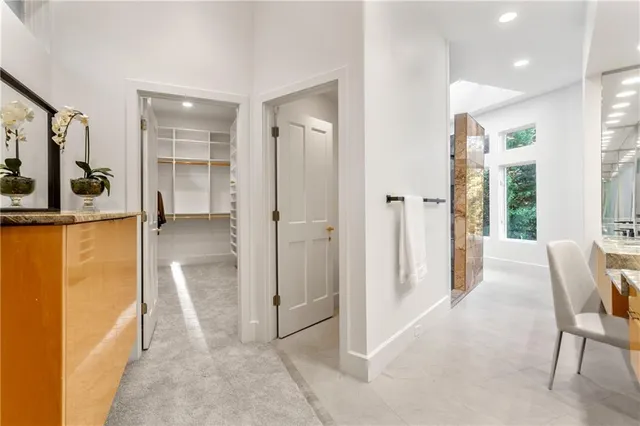 a view of a hallway with furniture and a living room