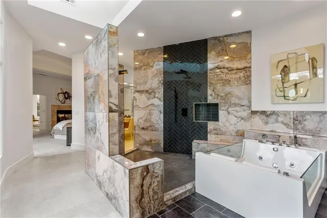 a bathroom with a tub sink and mirror