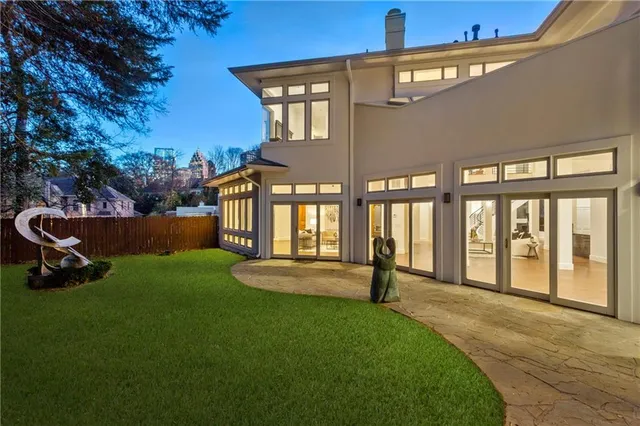 a view of an house with backyard and porch