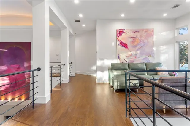 an open room with wooden floor and furniture