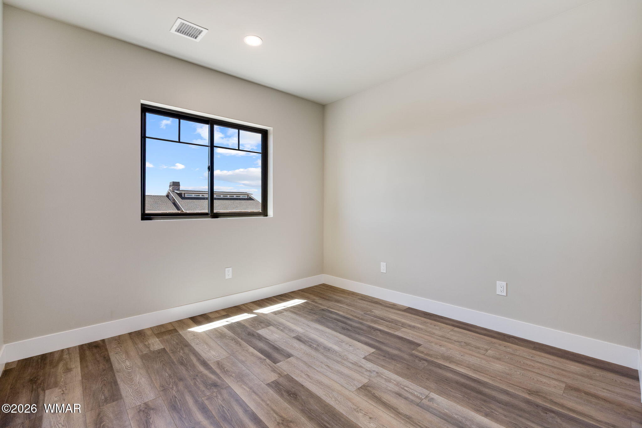561 South Rock Ridge Drive Show Low, AZ 85901 - Photo 17 of 28 an empty room with wooden floor and windows