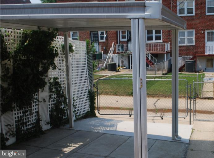1126 Kevin Road Baltimore, MD 21229 - Photo 11 of 24 a porch with a bench in front of building