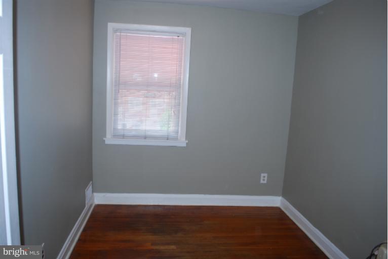 1126 Kevin Road Baltimore, MD 21229 - Photo 21 of 24 a view of a small space with wooden floor and a window