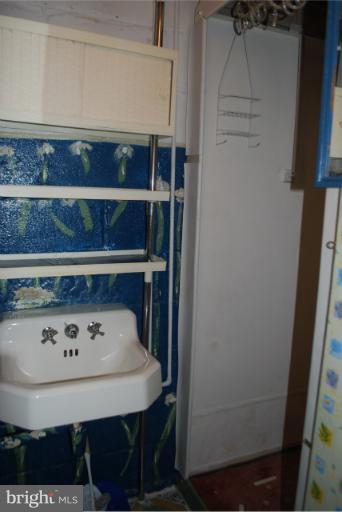1126 Kevin Road Baltimore, MD 21229 - Photo 22 of 24 a bathroom with a sink and a mirror