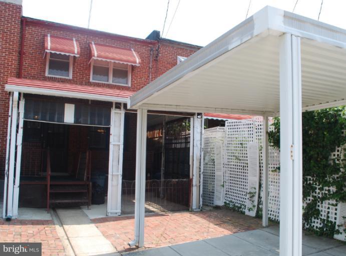 1126 Kevin Road Baltimore, MD 21229 - Photo 5 of 24 a front view of a house with a garage