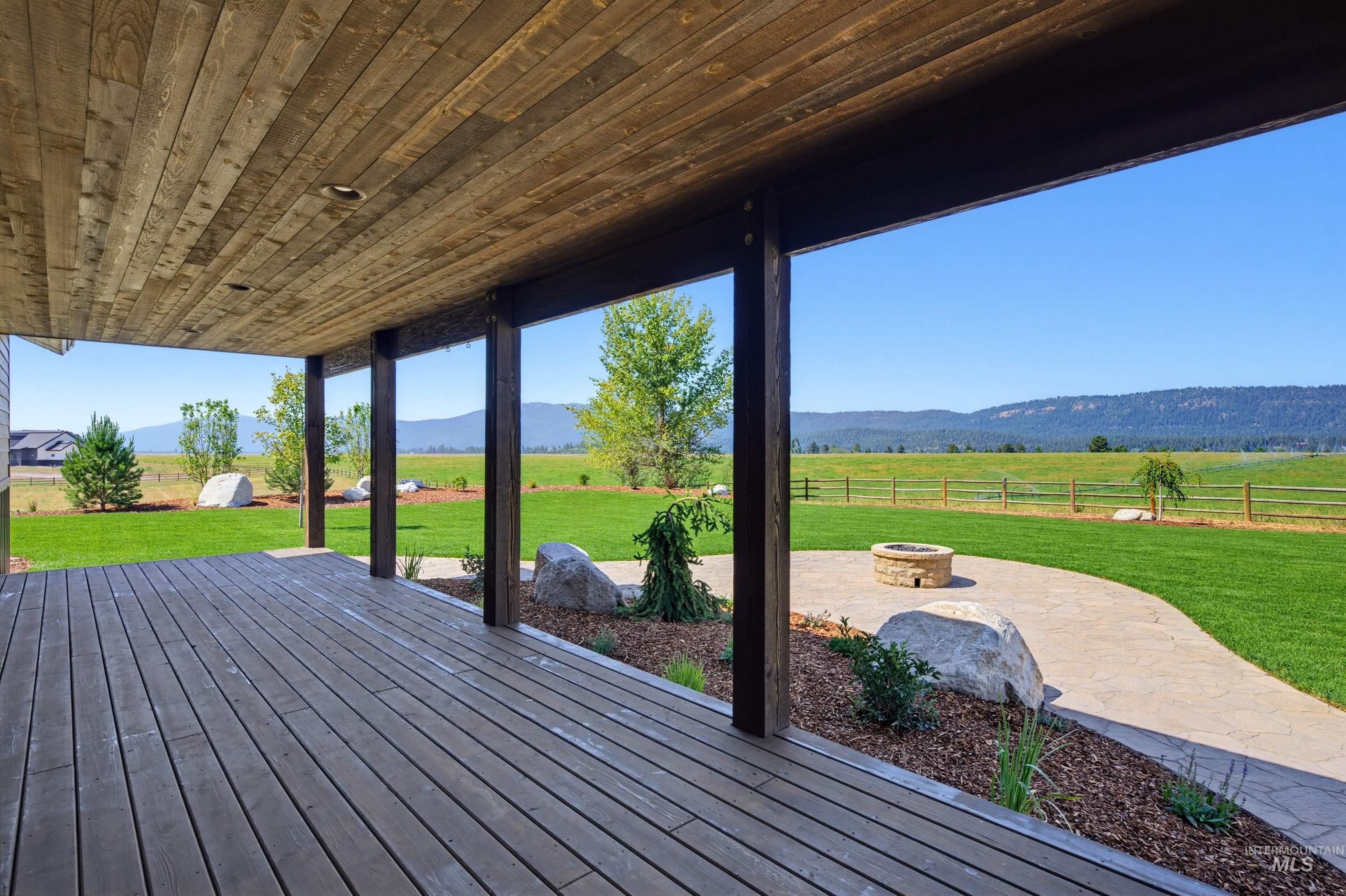 13945 Galloping Road McCall, ID 83638 - Photo 46 of 50 Covered outdoor living area featuring a wood-finish plank ceiling and coordinating wood-finish deck flooring