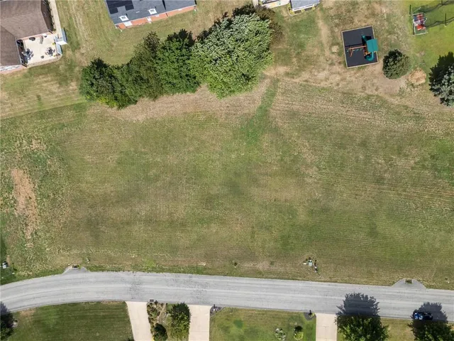 an aerial view of a houses with yard