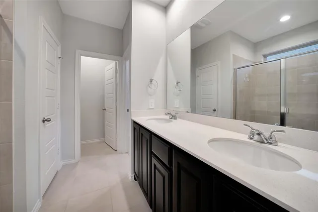 a bathroom with a double vanity sink mirror and double